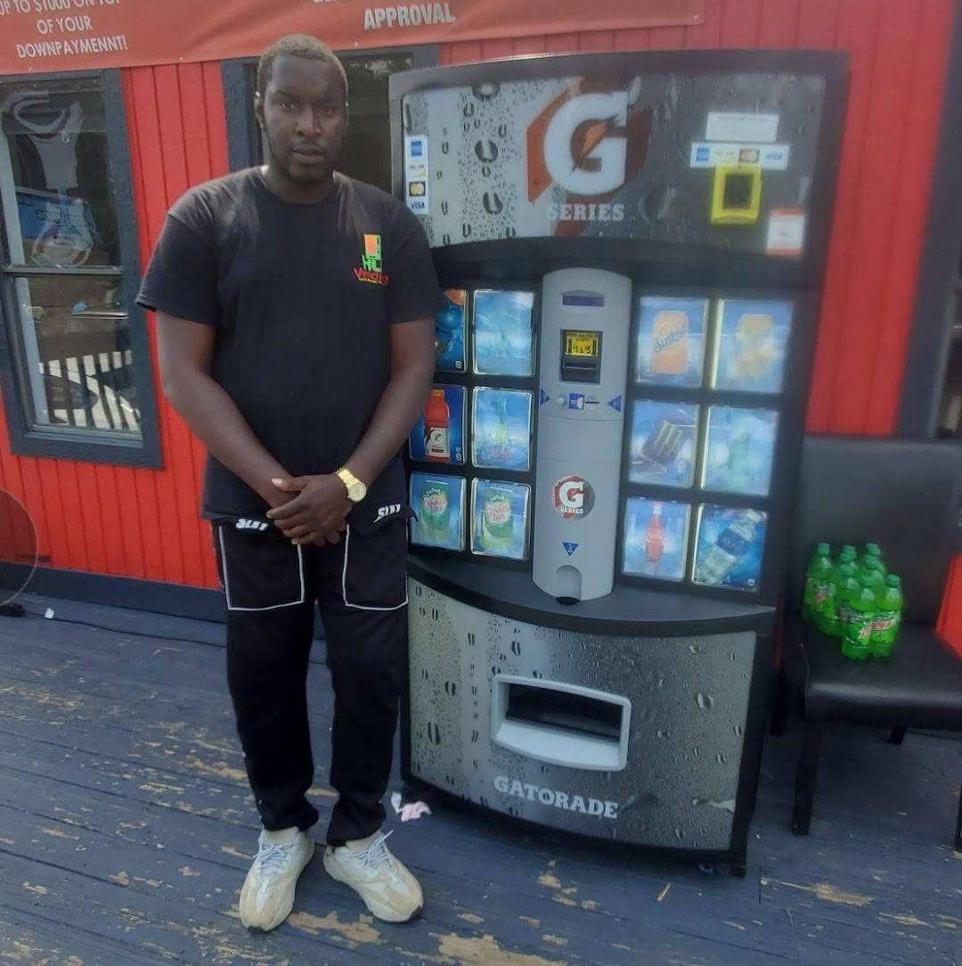 Jeff, founder of HU Vending, standing beside a vending machine